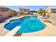 Backyard pool with a diving board, waterfall feature, and ample space for outdoor enjoyment at 1556 E Gabrilla Dr, Casa Grande, AZ 85122