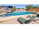 Sparkling pool in the backyard with lounge chairs, offering a perfect retreat for relaxation and recreation at 1556 E Gabrilla Dr, Casa Grande, AZ 85122