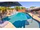 Backyard pool with a waterfall feature and stylish lounge chairs, creating a tranquil oasis for relaxation at 1556 E Gabrilla Dr, Casa Grande, AZ 85122