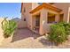 Side view of the house showing the low-maintenance landscaping and covered porch at 1556 E Gabrilla Dr, Casa Grande, AZ 85122