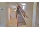 Well-lit stairway with carpeted steps and wooden railings, offering a safe and stylish transition between levels at 1556 E Gabrilla Dr, Casa Grande, AZ 85122