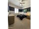A stylish bedroom with two-tone walls, a ceiling fan, and natural light at 15801 W Cielo Grande Ave, Surprise, AZ 85387