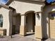 Charming front porch with an arched entrance and a view of the meticulously landscaped yard at 15801 W Cielo Grande Ave, Surprise, AZ 85387