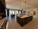 Gourmet kitchen with granite counters, double sinks and an open view of the dining and living areas at 15801 W Cielo Grande Ave, Surprise, AZ 85387