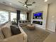 Inviting living room with modern fireplace, comfortable seating, and large windows offering plenty of natural light at 15801 W Cielo Grande Ave, Surprise, AZ 85387