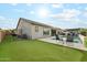 Beautiful backyard with a pool, putting green, and an outdoor living space at 16852 W Creedance Blvd, Surprise, AZ 85387