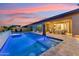 Resort-style backyard with a private pool, spa, and covered patio ideal for relaxation and outdoor living at 16852 W Creedance Blvd, Surprise, AZ 85387
