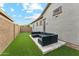 Private backyard with an artificial turf lawn and a cozy outdoor seating area at 16852 W Creedance Blvd, Surprise, AZ 85387