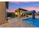 Luxurious outdoor living space featuring a bar, a pool, and a spacious patio with lounge chairs at 16852 W Creedance Blvd, Surprise, AZ 85387