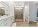 Bathroom featuring a single sink vanity, glass-enclosed shower, and separate toilet area at 16852 W Creedance Blvd, Surprise, AZ 85387