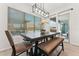 Dining room with natural light, modern chandelier, and seamless access to the outdoor patio at 16852 W Creedance Blvd, Surprise, AZ 85387
