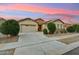 Beautiful single-story home with a stone-accented facade, desert landscaping, and a well-maintained front yard in a quiet neighborhood at 16852 W Creedance Blvd, Surprise, AZ 85387