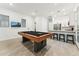 Spacious game room with a pool table, kitchen bar, and ample space for entertaining guests at 16852 W Creedance Blvd, Surprise, AZ 85387