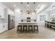 Modern kitchen boasts white cabinetry, stainless steel appliances, and a spacious center island at 16852 W Creedance Blvd, Surprise, AZ 85387