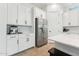 Kitchen featuring white cabinets, stainless steel appliances and a breakfast bar at 16852 W Creedance Blvd, Surprise, AZ 85387