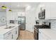 Well-equipped kitchen featuring stainless steel appliances, white cabinetry and modern finishes at 16852 W Creedance Blvd, Surprise, AZ 85387