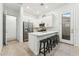 Modern kitchen with white cabinets, stainless steel appliances, and a stylish breakfast bar at 16852 W Creedance Blvd, Surprise, AZ 85387