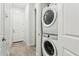 Convenient laundry room featuring a stacked washer and dryer unit, maximizing space at 16852 W Creedance Blvd, Surprise, AZ 85387