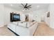 Bright and airy living room offering ample seating and a modern entertainment center at 16852 W Creedance Blvd, Surprise, AZ 85387