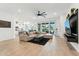 Bright, open living room with tile floors, modern furnishings, and seamless indoor-outdoor flow at 16852 W Creedance Blvd, Surprise, AZ 85387
