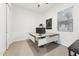 Bright home office featuring a built-in desk, window with blinds, and neutral carpeting at 16852 W Creedance Blvd, Surprise, AZ 85387