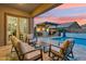 Inviting outdoor living space featuring a covered patio, a pool, and a cozy seating area at 16852 W Creedance Blvd, Surprise, AZ 85387