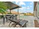 Inviting outdoor living space with a bar area, lounge chairs, and a sparkling swimming pool at 16852 W Creedance Blvd, Surprise, AZ 85387