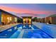 Inviting backyard pool with a swim up bar and outdoor kitchen, perfect for entertaining on summer evenings at 16852 W Creedance Blvd, Surprise, AZ 85387