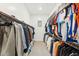 Spacious walk-in closet featuring rods for hanging clothes and built-in shelving at 16852 W Creedance Blvd, Surprise, AZ 85387
