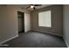 Bedroom featuring neutral carpet, a window and a closet with sliding doors at 1804 W Kristal Way, Phoenix, AZ 85027