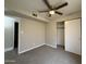 Bedroom features neutral carpet, ceiling fan, and a sliding door closet at 1804 W Kristal Way, Phoenix, AZ 85027