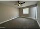 Bedroom features neutral carpet, ceiling fan, and a window providing natural light at 1804 W Kristal Way, Phoenix, AZ 85027
