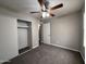 Bedroom with neutral carpet, ceiling fan and access to the closet at 1804 W Kristal Way, Phoenix, AZ 85027