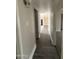 Hallway with modern wood-look flooring leading to other rooms, neutral colored walls, and clean white trim at 1804 W Kristal Way, Phoenix, AZ 85027