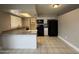Kitchen features white cabinets, black appliances, and tiled flooring at 1804 W Kristal Way, Phoenix, AZ 85027