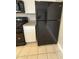 Modern black refrigerator and range with white cabinets at 1804 W Kristal Way, Phoenix, AZ 85027