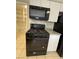 Modern black range with cooktop and microwave with white cabinets at 1804 W Kristal Way, Phoenix, AZ 85027