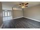 Open-concept living room featuring modern flooring, neutral paint, and a ceiling fan at 1804 W Kristal Way, Phoenix, AZ 85027