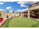 This backyard features a putting green, covered patio, and privacy wall at 1912 S Colt Dr, Gilbert, AZ 85295