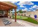 Backyard patio featuring a putting green, beautiful stonework, and a pergola with hanging lights at 1912 S Colt Dr, Gilbert, AZ 85295