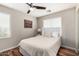 This cozy bedroom is well lit with wood laminate flooring, ceiling fan and a double bed at 1912 S Colt Dr, Gilbert, AZ 85295