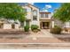 Charming two-story home with landscaped yard, covered porch, and appealing desert-toned exterior at 1912 S Colt Dr, Gilbert, AZ 85295