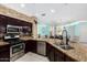 Well-equipped kitchen with granite counters, stainless appliances, and seamless flow into dining at 1912 S Colt Dr, Gilbert, AZ 85295