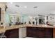Open kitchen with granite countertops, stainless steel appliances, and modern lighting at 1912 S Colt Dr, Gilbert, AZ 85295