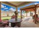 This covered patio features wicker furniture, a grill, and a view of the putting green at 1912 S Colt Dr, Gilbert, AZ 85295