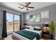 Bedroom featuring a ceiling fan, access to a balcony, and neutral colored walls at 19475 N Grayhawk Dr # 2151, Scottsdale, AZ 85255
