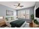 A spacious bedroom with a ceiling fan, shuttered windows, and blue-grey walls at 19475 N Grayhawk Dr # 2151, Scottsdale, AZ 85255