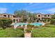 Community pool surrounded by lush landscaping and seating areas at 19475 N Grayhawk Dr # 2151, Scottsdale, AZ 85255