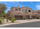 Beautiful townhome featuring a stone facade, private balconies, and attached garages in a well-maintained community at 19475 N Grayhawk Dr # 2151, Scottsdale, AZ 85255