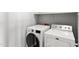 A well-lit laundry room with a modern washer and dryer at 19475 N Grayhawk Dr # 2151, Scottsdale, AZ 85255